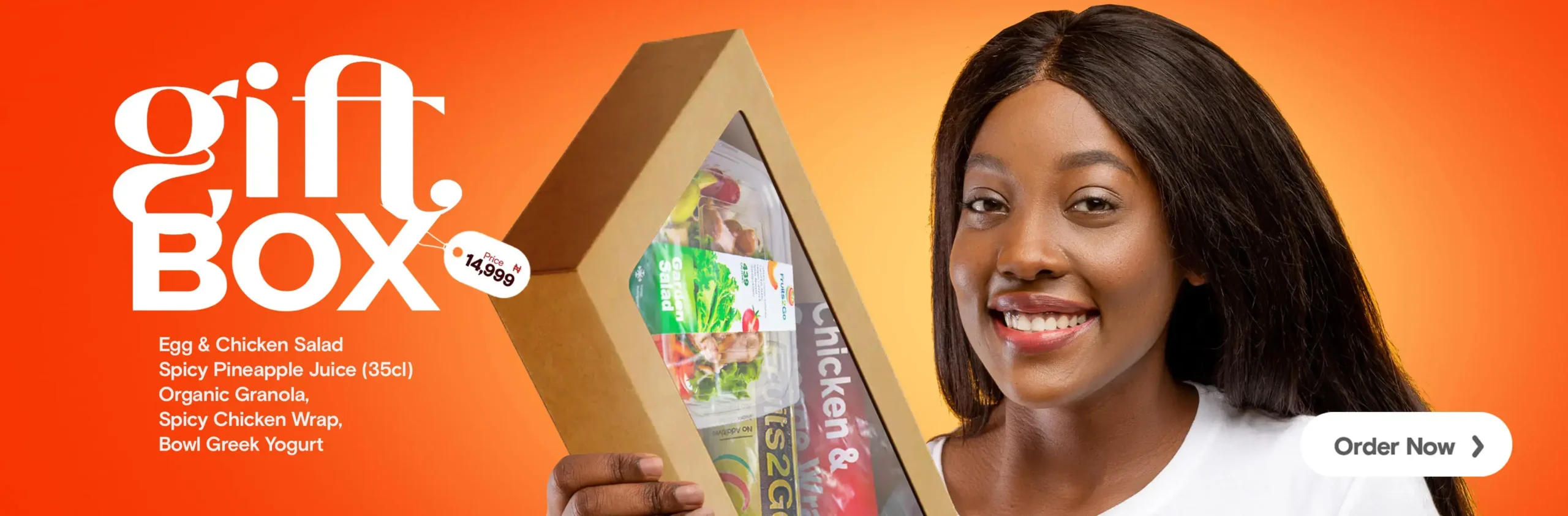 a woman holding a box of food